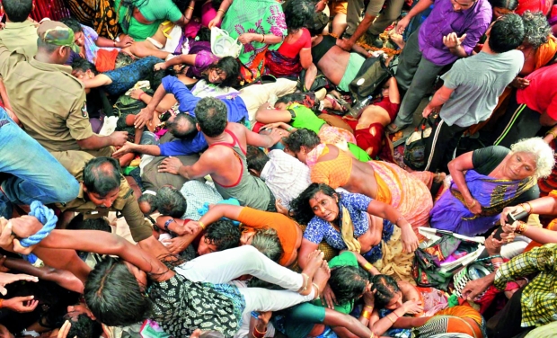 People scramble among the dead to save those who are alive after the stampede at the Rajahmundry Pushkar ghat where 27 people were killed in the heavy rush of pilgrims (Photo: Ch. Narayana Rao) People scramble among the dead to save those who are alive after the stampede at the Rajahmundry Pushkar ghat where 27 people were killed in the heavy rush of pilgrims (Photo: Ch. Narayana Rao)